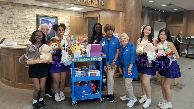 University High School cheerleaders donating toys to children at Providence Hospital.